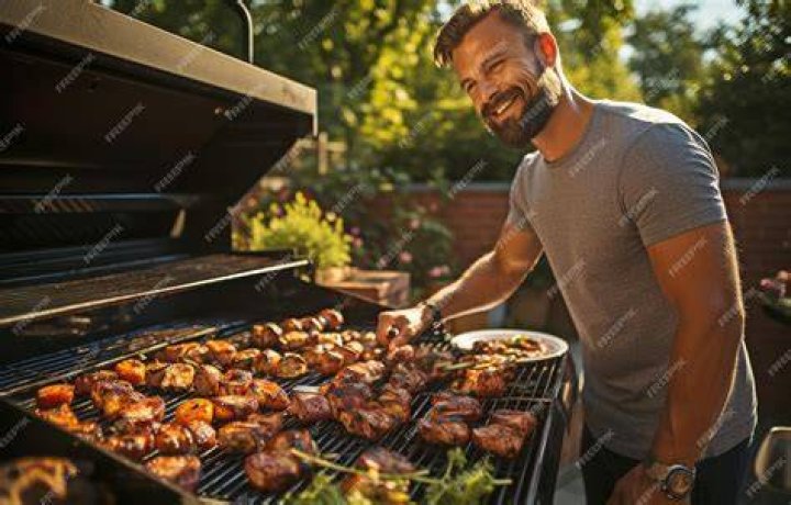 Man Grilling Herrings At Oktoberfest