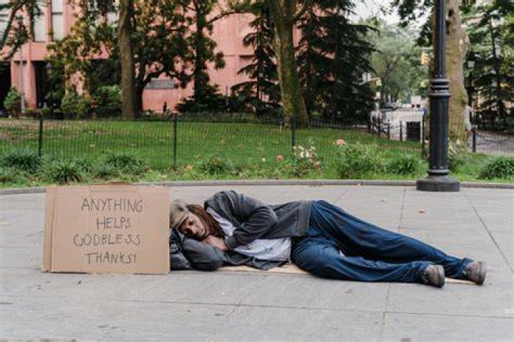 Man Sleeping On Sidewalk