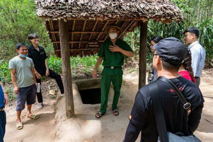 Men Reaching Into Vietcong Tunnel